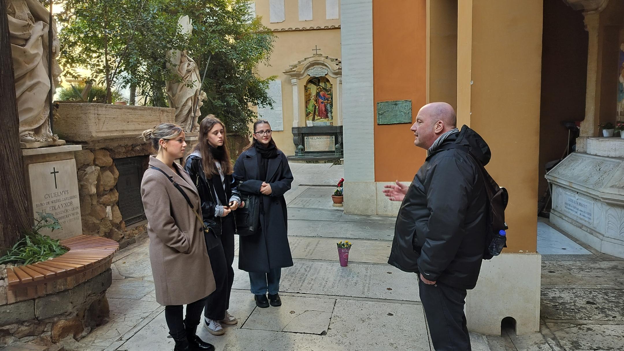 Giulia Tuttolomondo, Lisa Lambert, Louisa König (von links) besichtigen mit Pastoralreferent Markus-Krogull-Kalb den Campo Santo Teutonico im Vatikan.